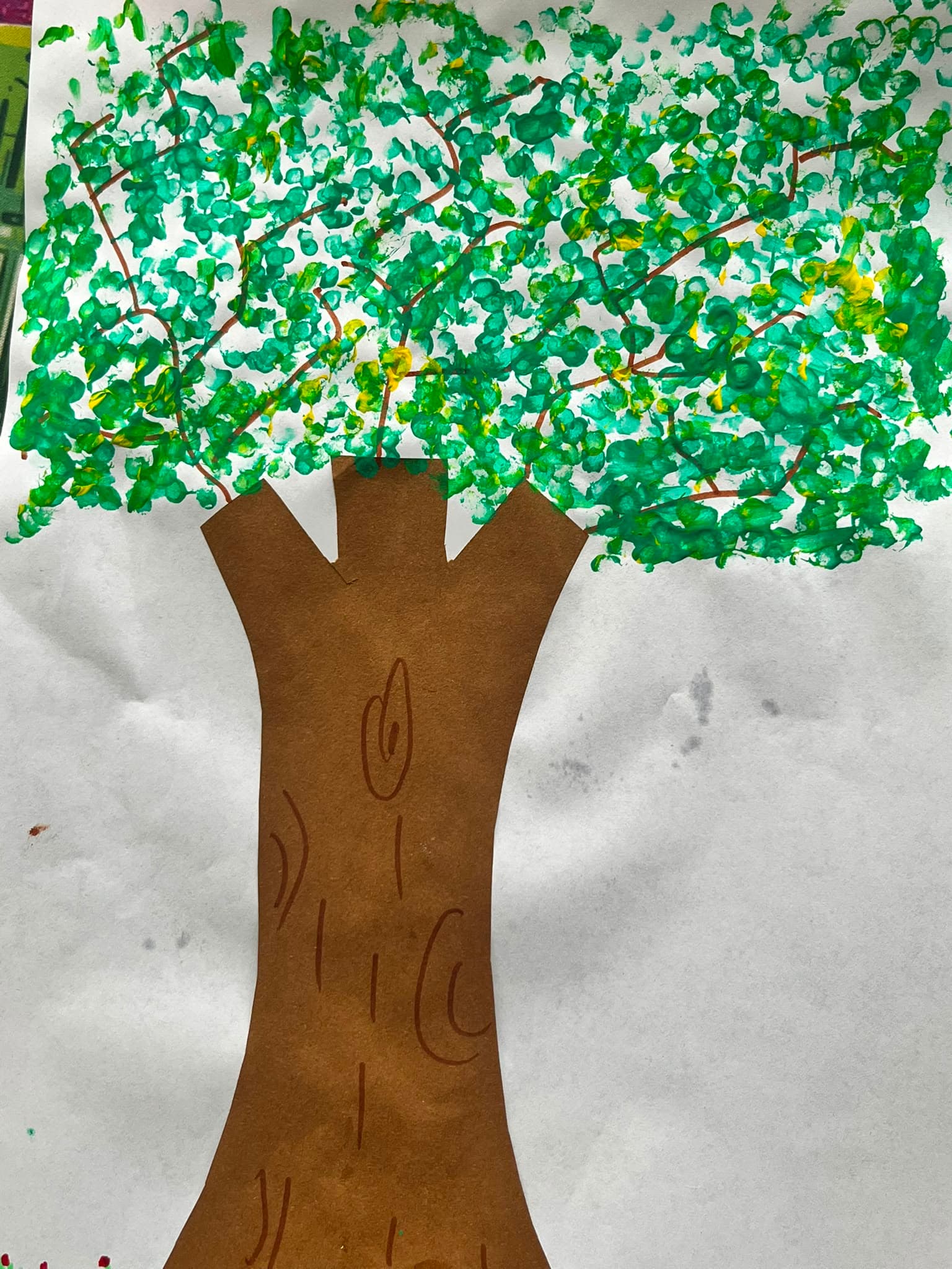 A fingerprint-painted tree, part of a nature theme at a Youth Active Arts & Craft session